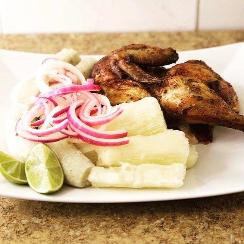 John's Fried Chicken: a plate of fried chicken, yucca, plantains, red onions, and lime wedges.